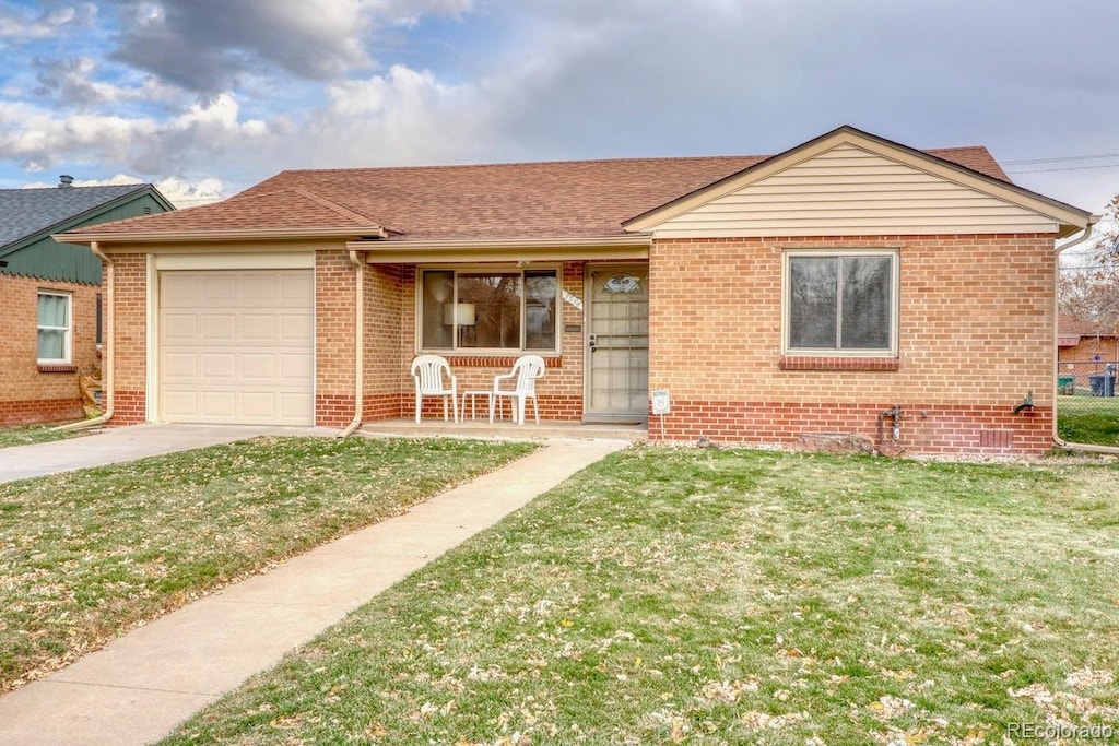 view of front of home with a front yard, a porch, and a garage