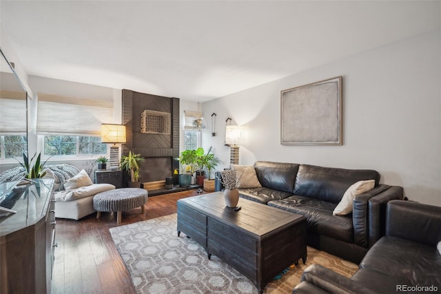 living room featuring hardwood / wood-style floors and a brick fireplace