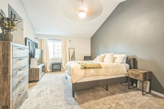 bedroom featuring vaulted ceiling, light carpet, baseboards, and a ceiling fan