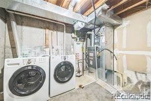 1470 S Quebec Way Unit 8, Denver, CO 80231 - laundry room featuring water heater and separate washer and dryer