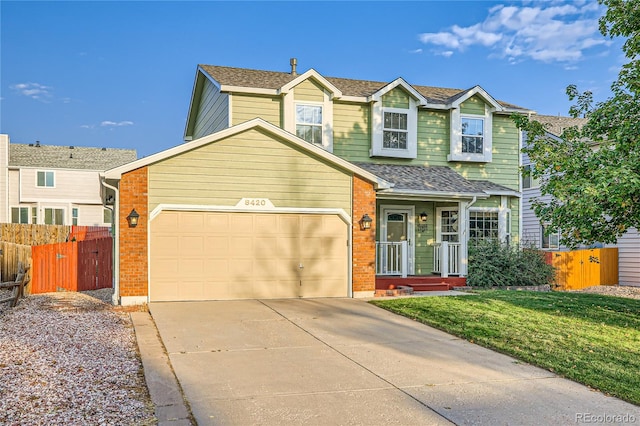 view of front of property with a garage and a front lawn