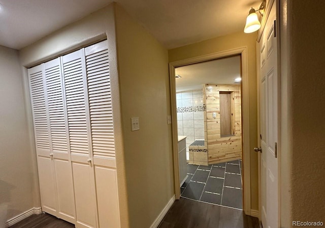 hallway with baseboards and dark wood-style floors
