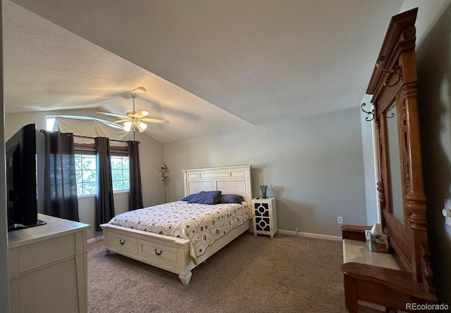 carpeted bedroom featuring a textured ceiling, a ceiling fan, baseboards, and vaulted ceiling