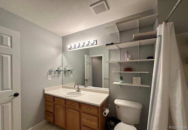 bathroom featuring vanity, visible vents, curtained shower, toilet, and a textured wall