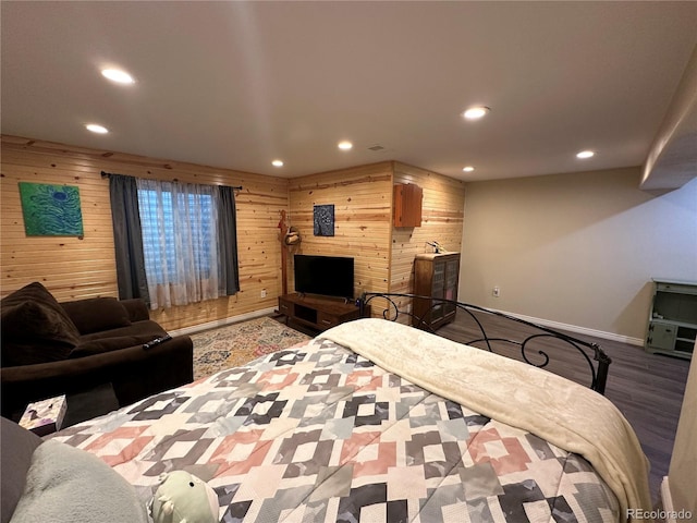 bedroom with wooden walls, recessed lighting, and wood finished floors