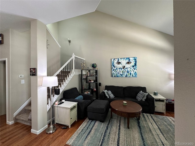 living room with vaulted ceiling and light hardwood / wood-style flooring