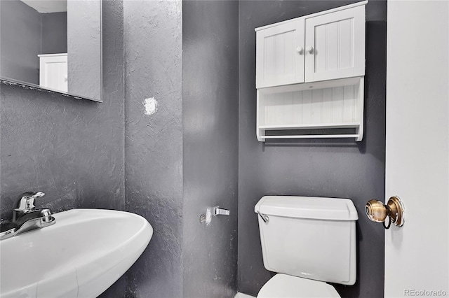 bathroom featuring sink and toilet