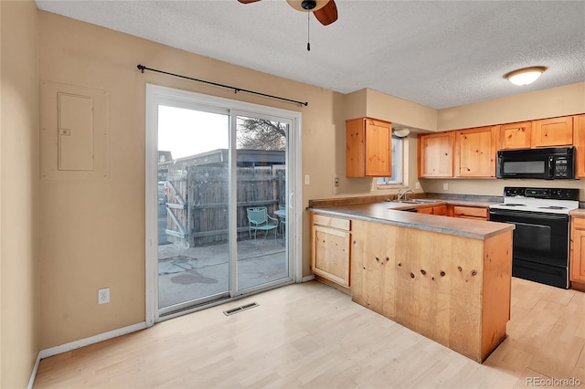 kitchen featuring electric range, ceiling fan, electric panel, light hardwood / wood-style floors, and a textured ceiling