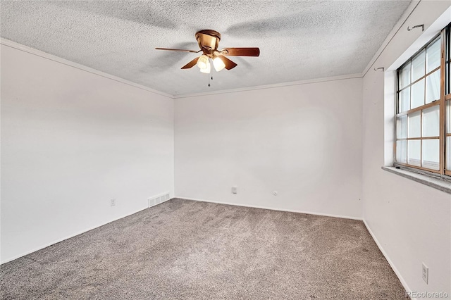 spare room featuring carpet, a textured ceiling, ceiling fan, and crown molding