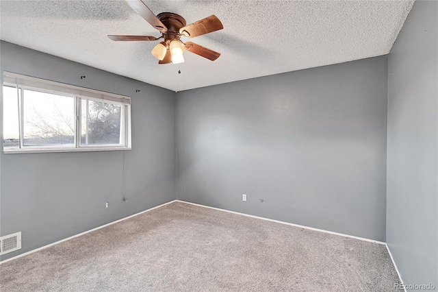 carpeted empty room featuring a textured ceiling and ceiling fan