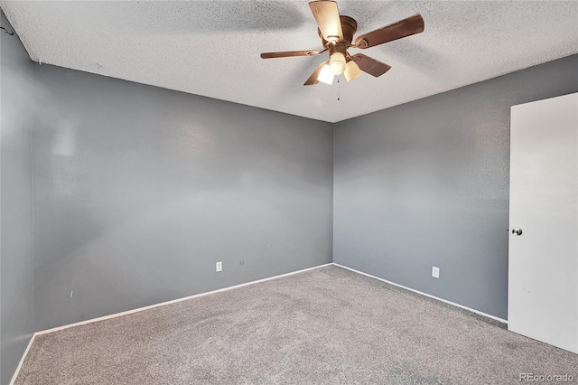 carpeted empty room featuring a textured ceiling and ceiling fan