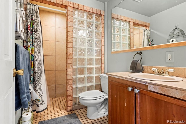 7400 W Quincy Ave, Littleton, CO 80123 - full bath featuring a tile shower, vanity, and tile patterned floors