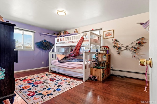 7400 W Quincy Ave, Littleton, CO 80123 - bedroom featuring baseboard heating and wood finished floors