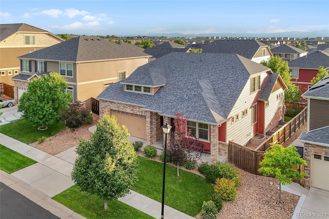 4875 S Catawba St, Aurora, CO 80016 - view of front facade with a residential view, a garage, stone siding, and roof with shingles