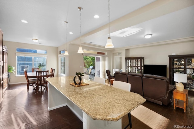 4875 S Catawba St, Aurora, CO 80016 - kitchen featuring a kitchen bar, dark wood finished floors, plenty of natural light, and recessed lighting