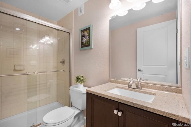 4875 S Catawba St, Aurora, CO 80016 - bathroom with a tile shower, vanity, and a textured wall