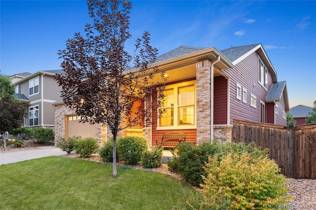 4875 S Catawba St, Aurora, CO 80016 - view of front of home with driveway, stone siding, roof with shingles, and an attached garage