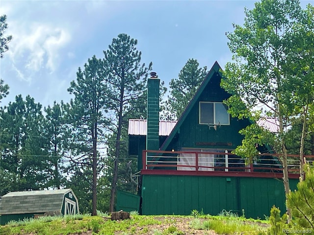 413 W Lake Dr, Divide, CO 80814 - view of property exterior featuring a metal roof and a chimney