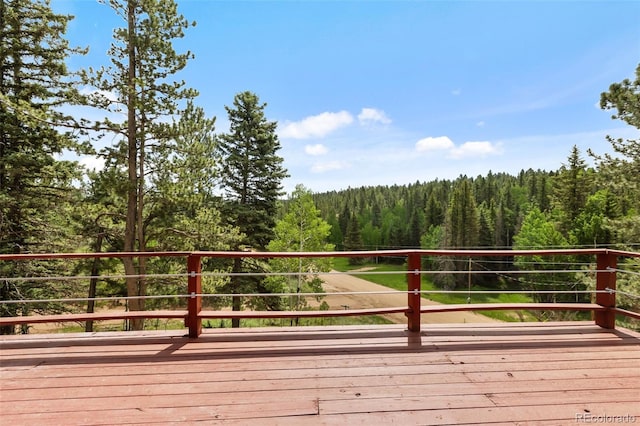 413 W Lake Dr, Divide, CO 80814 - wooden deck featuring a view of trees
