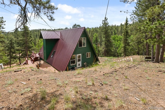413 W Lake Dr, Divide, CO 80814 - view of side of home with a wooded view, a metal roof, and a standing seam roof