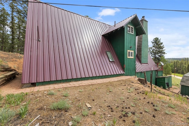 413 W Lake Dr, Divide, CO 80814 - view of side of home with a chimney and a metal roof