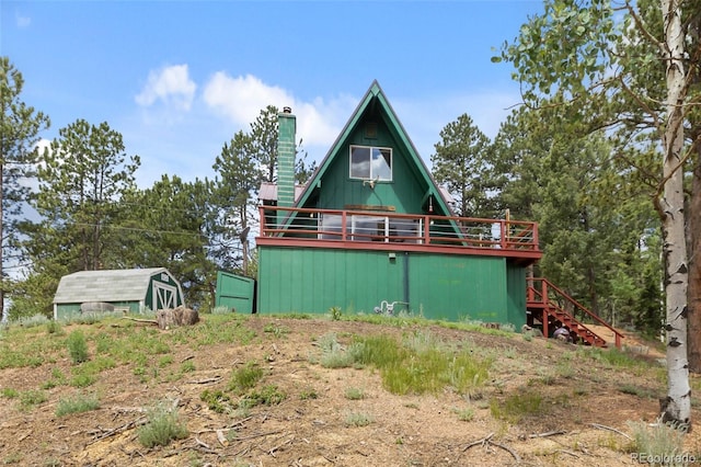 413 W Lake Dr, Divide, CO 80814 - view of front of home featuring a chimney, stairway, and a deck