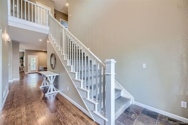 stairway featuring a high ceiling