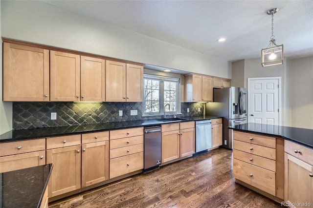 kitchen with hanging light fixtures, appliances with stainless steel finishes, sink, and light brown cabinets