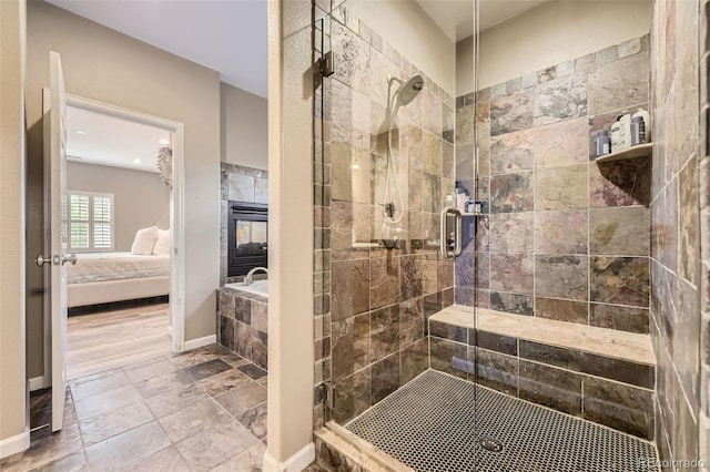 bathroom featuring a fireplace and a shower with door