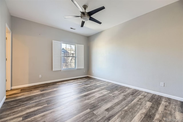 unfurnished room with ceiling fan and dark hardwood / wood-style flooring