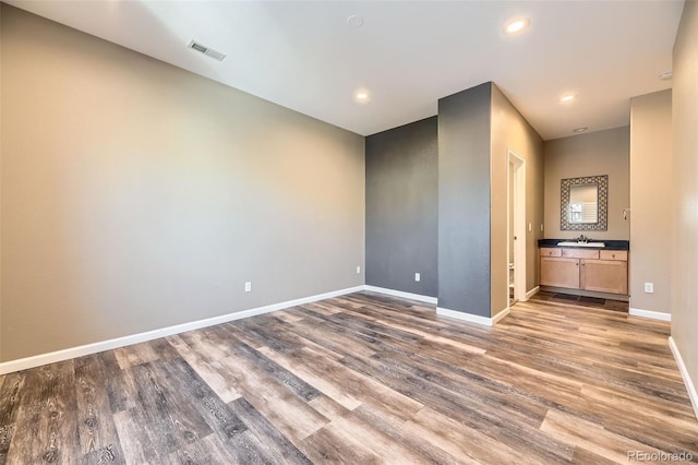 empty room with wood-type flooring and sink