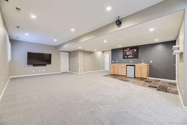 unfurnished living room featuring light colored carpet and wet bar