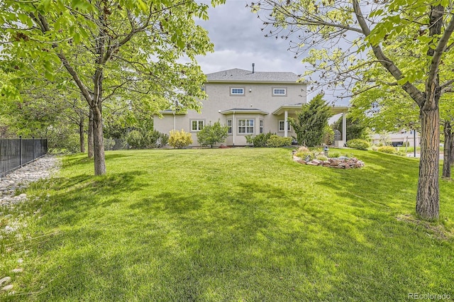 back of house with a lawn