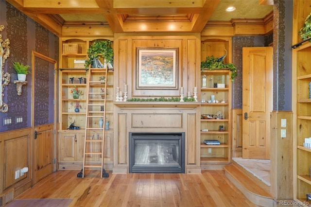 1975 Fox Mountain Pt, Colorado Springs, CO 80906 - unfurnished living room with coffered ceiling, wood-type flooring, ornamental molding, beamed ceiling, and a glass covered fireplace