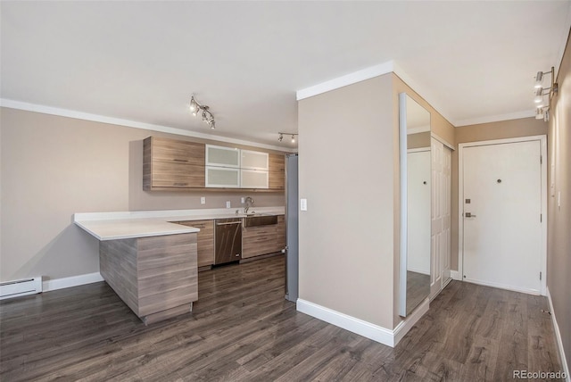 kitchen featuring dark wood finished floors, crown molding, stainless steel appliances, light countertops, and a peninsula