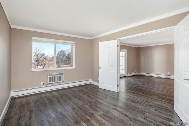 spare room featuring dark wood-style flooring, ornamental molding, and baseboard heating