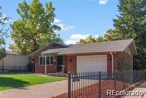 ranch-style home with a garage, driveway, a front lawn, and a fenced front yard