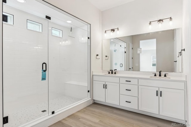 bathroom with vanity, wood-type flooring, and walk in shower