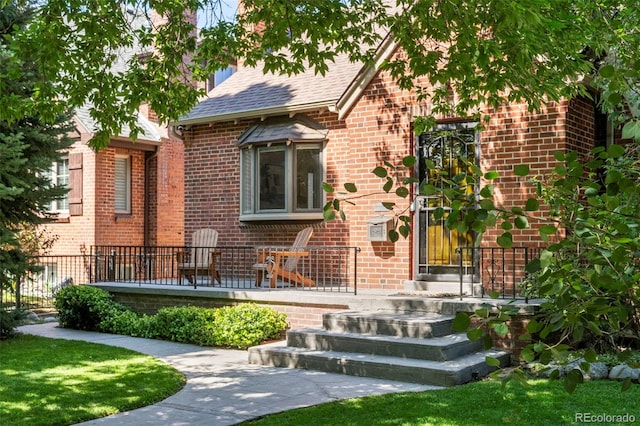 1265 S Elizabeth St, Denver, CO 80210 - view of front facade featuring brick siding and roof with shingles