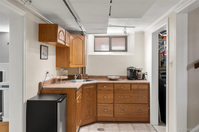 1265 S Elizabeth St, Denver, CO 80210 - kitchen featuring brown cabinetry, light tile patterned flooring, fridge, light countertops, and ornamental molding