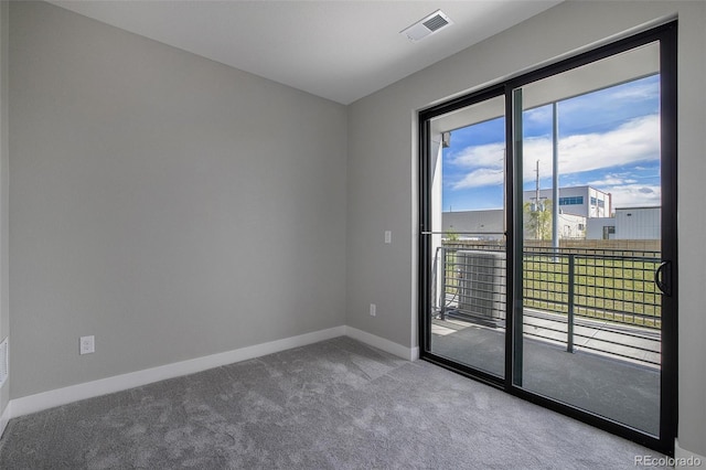 unfurnished room featuring carpet flooring, baseboards, and visible vents