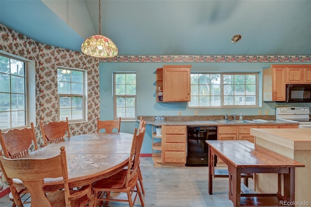 319 W Arkansas St, Buena Vista, CO 81211 - kitchen with black appliances, light brown cabinets, wallpapered walls, light wood-style floors, and light countertops