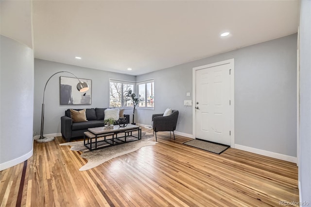 living room with light wood finished floors, baseboards, and recessed lighting