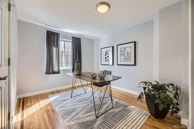 office area featuring baseboards and wood finished floors