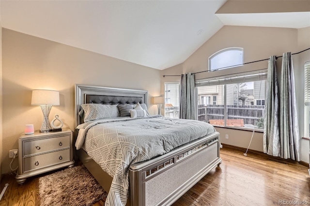 bedroom featuring wood finished floors and vaulted ceiling