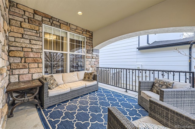 exterior space featuring a balcony and outdoor lounge area