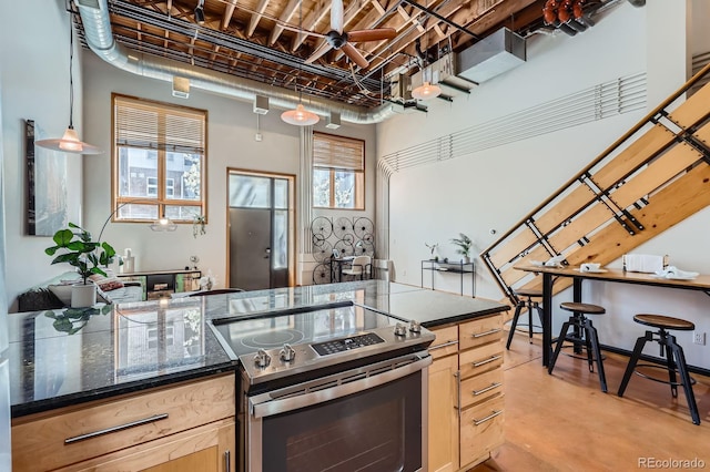2715 Blake St Unit 2, Denver, CO 80205 - kitchen with electric range, concrete flooring, light brown cabinets, and a ceiling fan