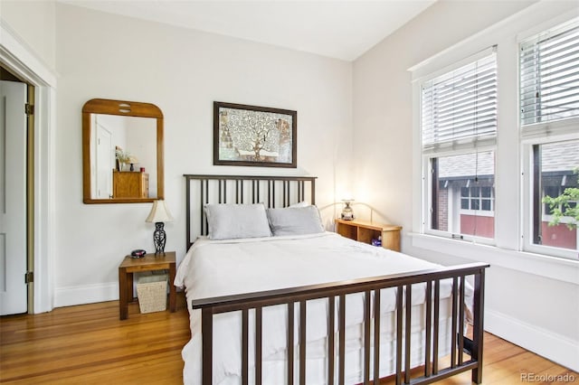bedroom featuring baseboards and light wood-style flooring
