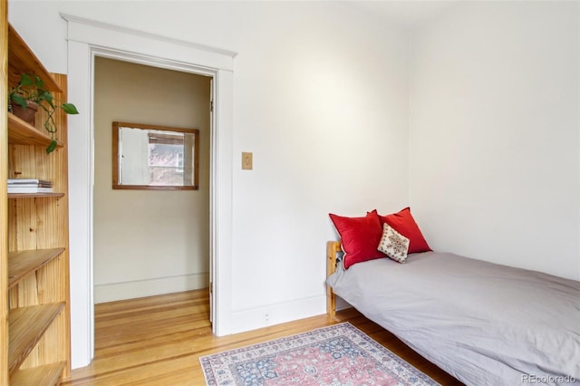 bedroom with baseboards and light wood-style flooring
