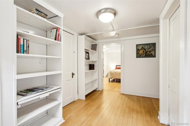 hallway featuring visible vents and light wood finished floors